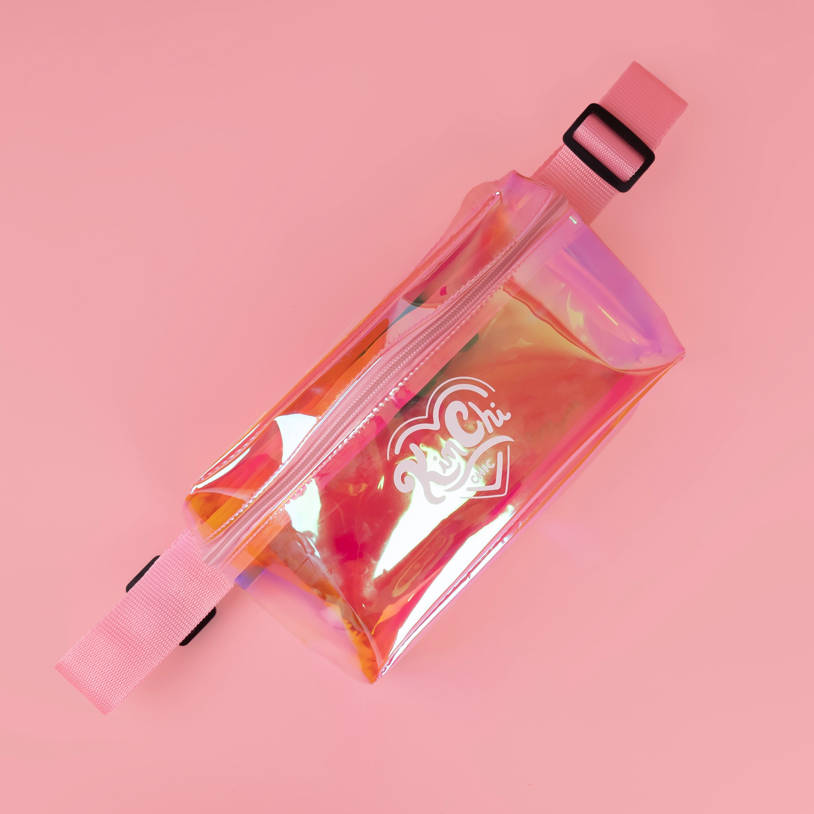 Holographic waist bag with a pink strap on a pink background