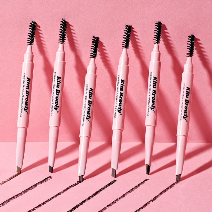 Set of Kim Browly eyebrow pencils in pink, featuring a dual-ended design with brush and pencil tip.