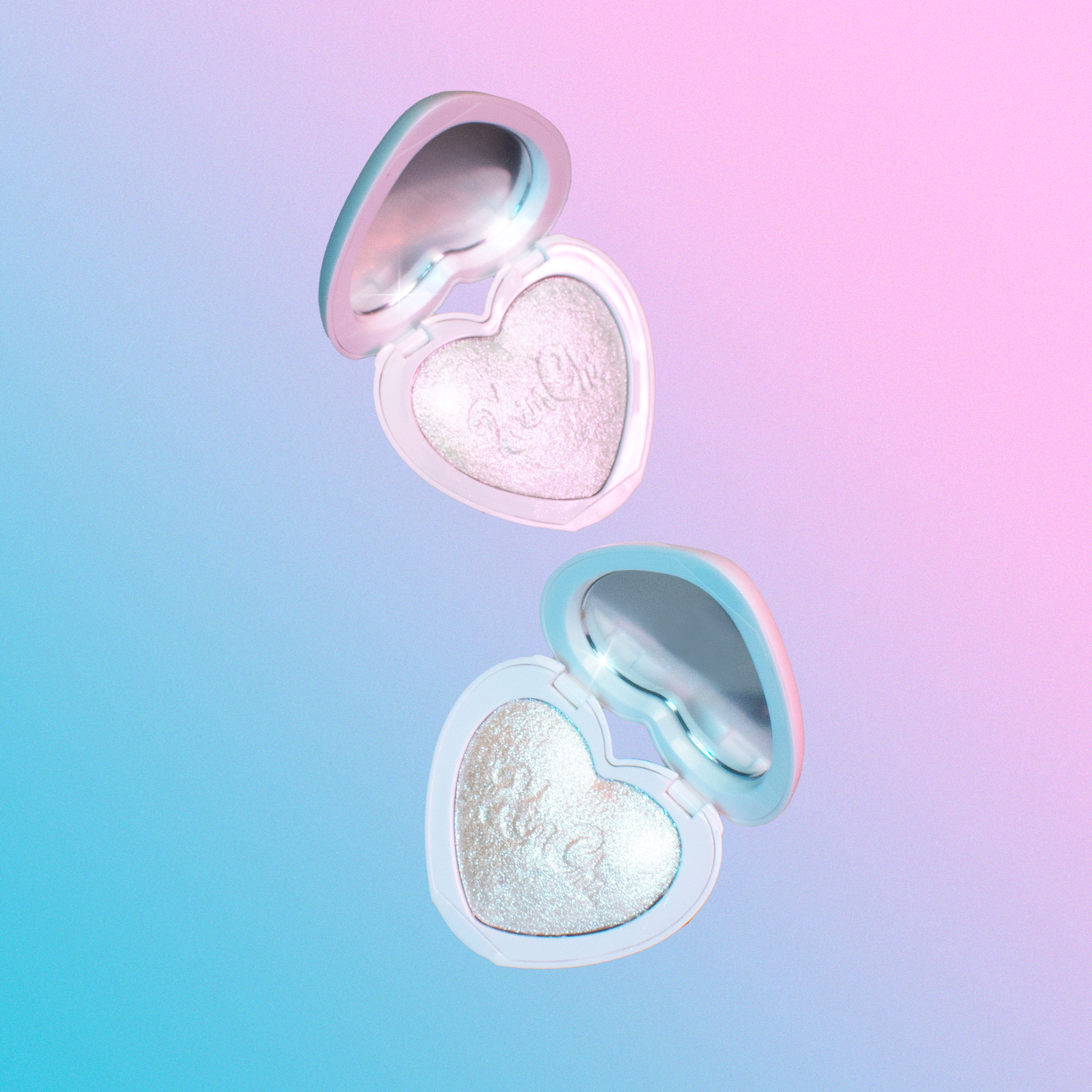 Heart-shaped highlighter compacts in iridescent shades, featuring shimmering pearl finish.