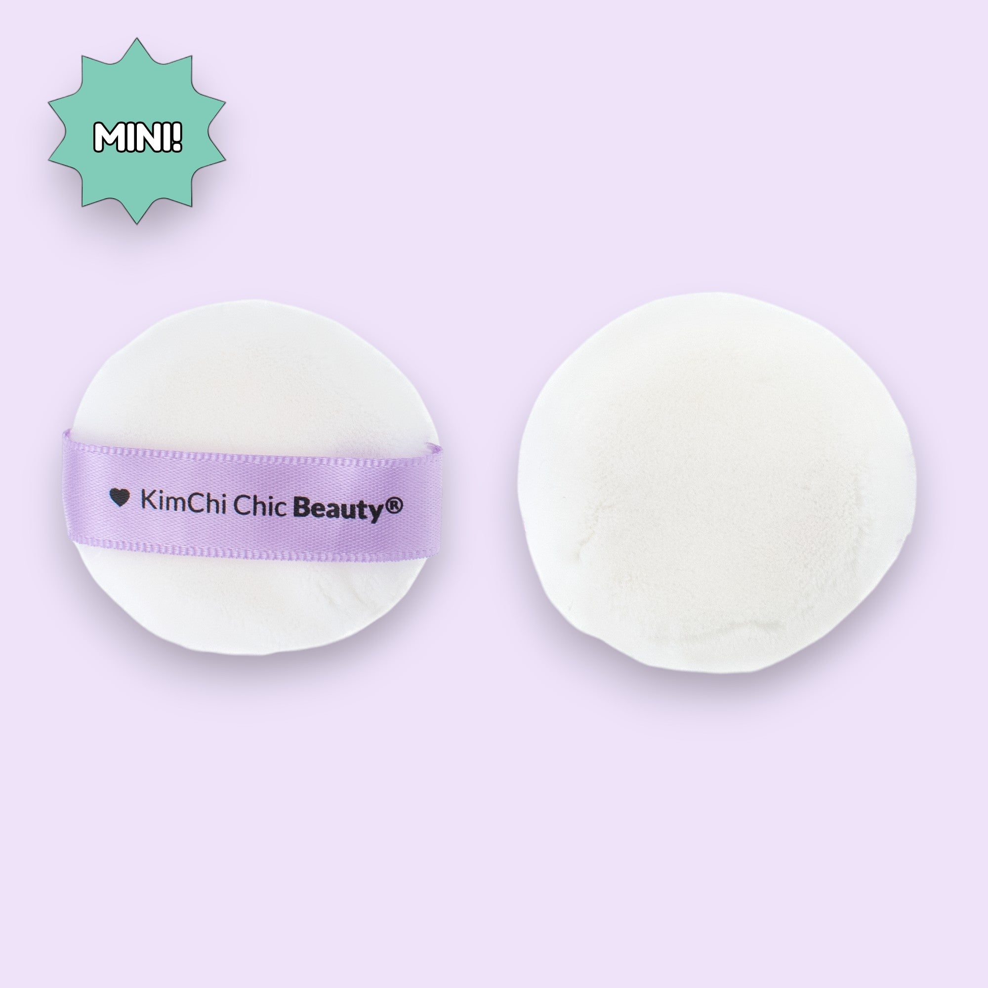 Mini white powder puff by KimChi Chic Beauty, soft material with a lavender strap for easy use.