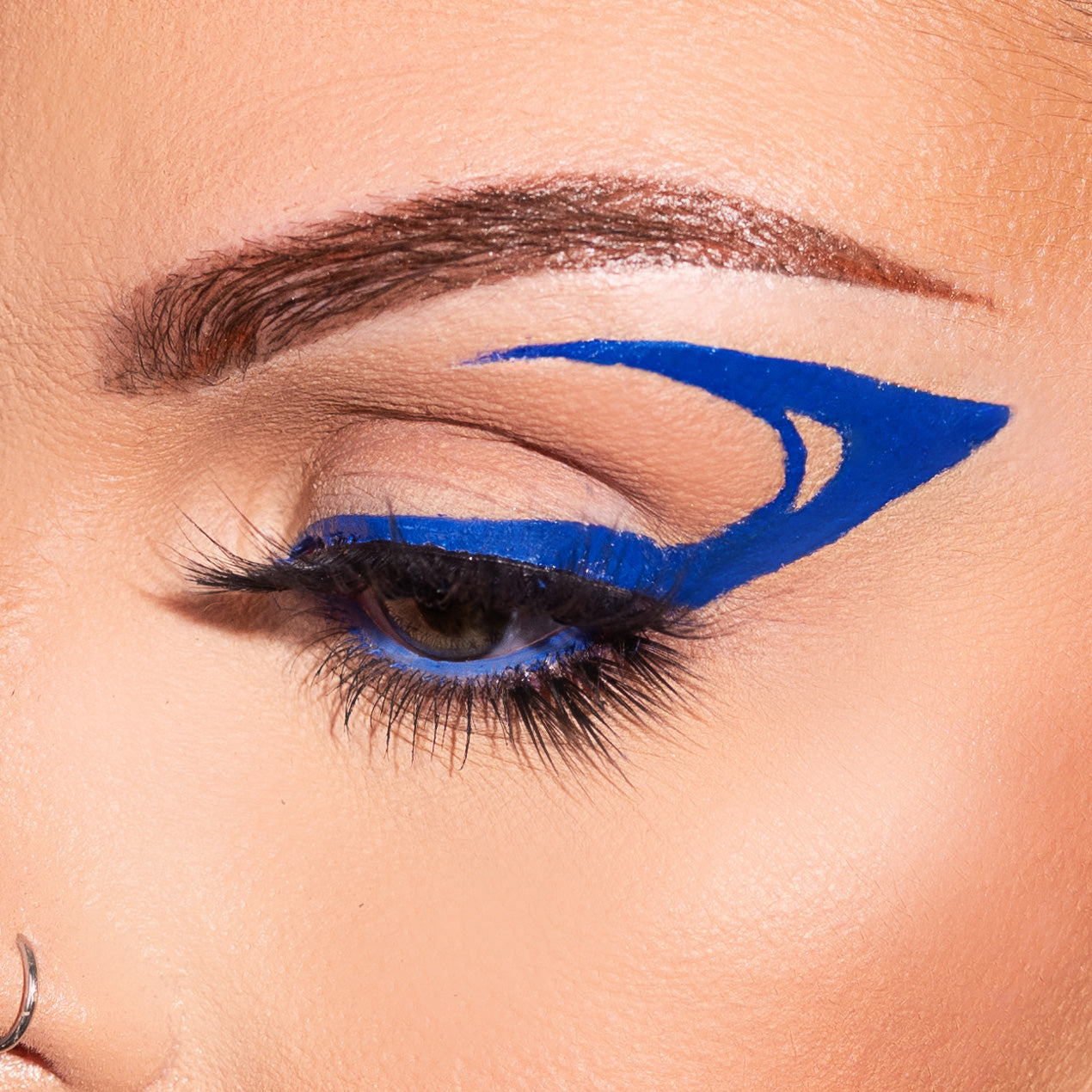 Close-up of an eye with striking blue eyeliner design.