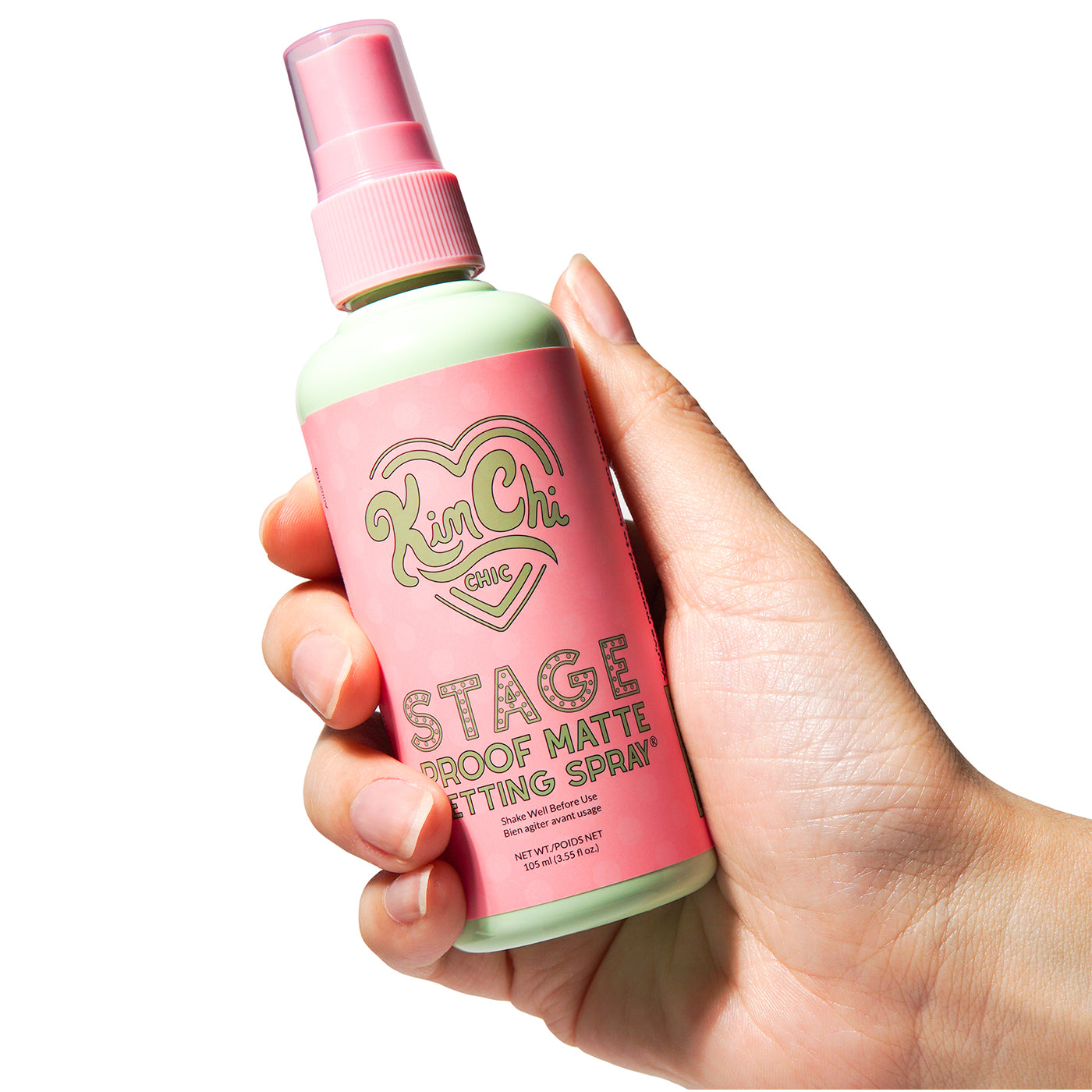 Hand holding a bottle of Ken Chi Stage Proof Matte Setting Spray