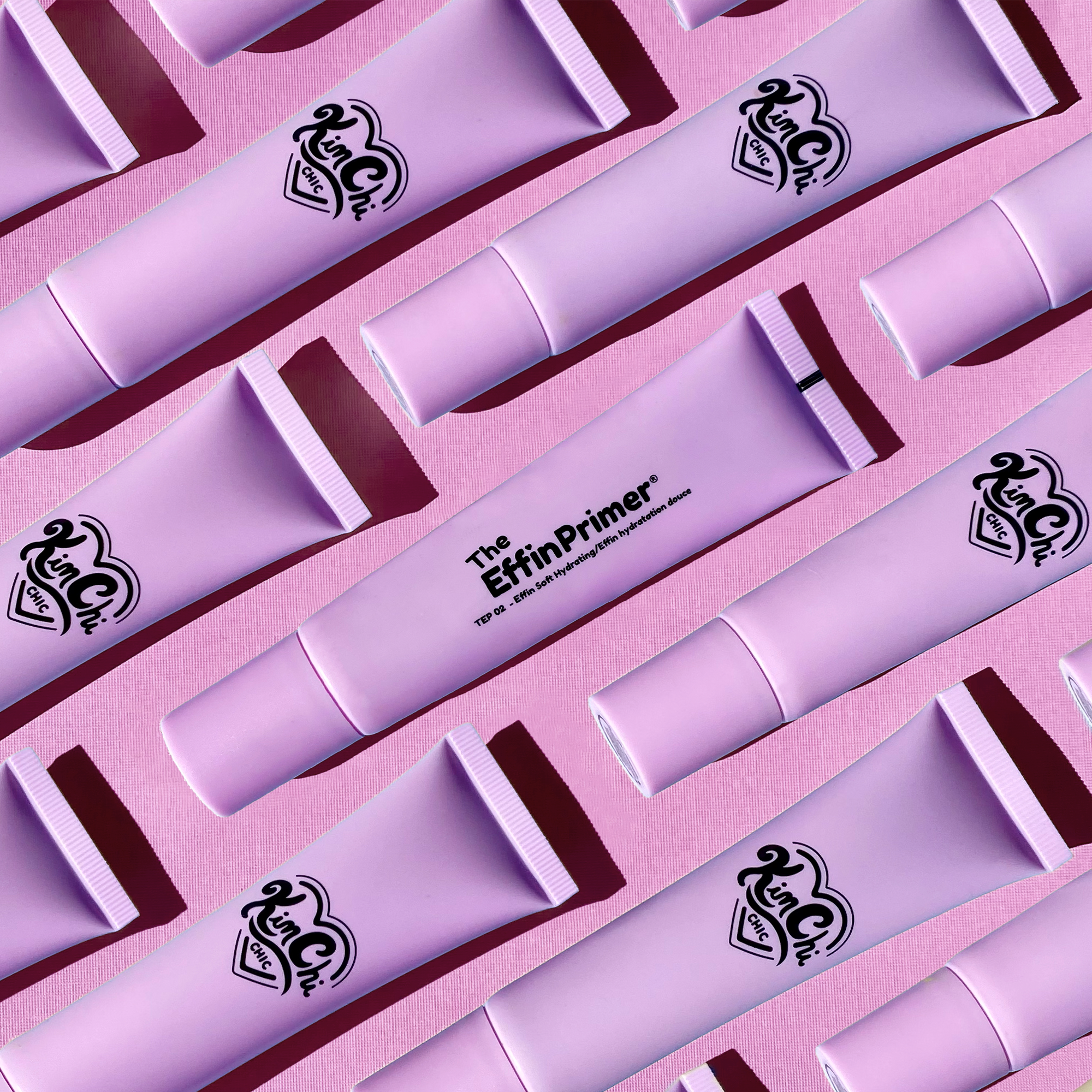 Kim Chi The EffinPrimer® in purple tubes on a pink background, ideal for enhancing makeup longevity.