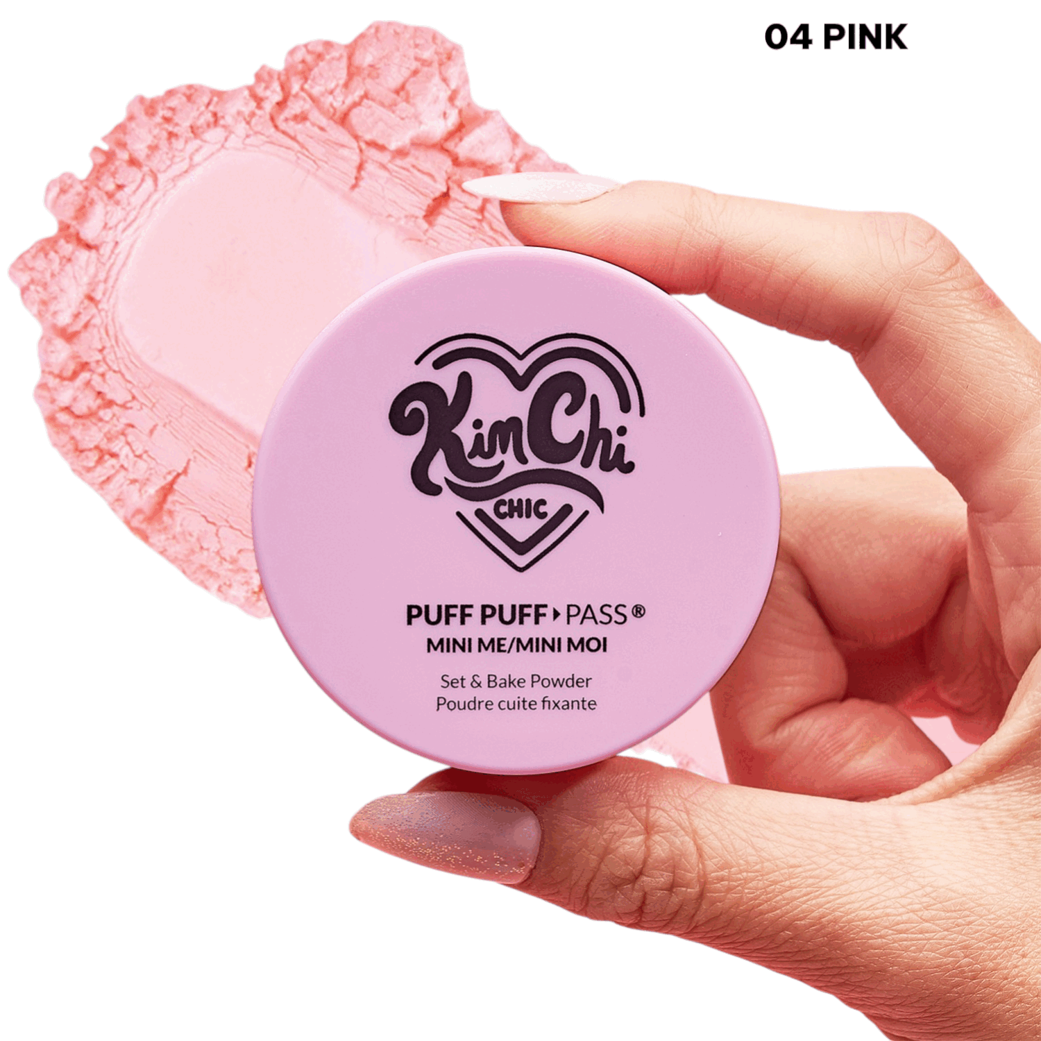 Hand holding a pink container of Kim Chi Chic Puff Puff Pass Mini Loose Powder.