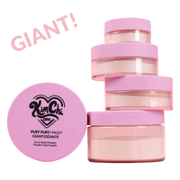 A stack of pink-capped jars of Kim Chi Puff Puff Pass setting powder, with a label that reads 'GIANT!'