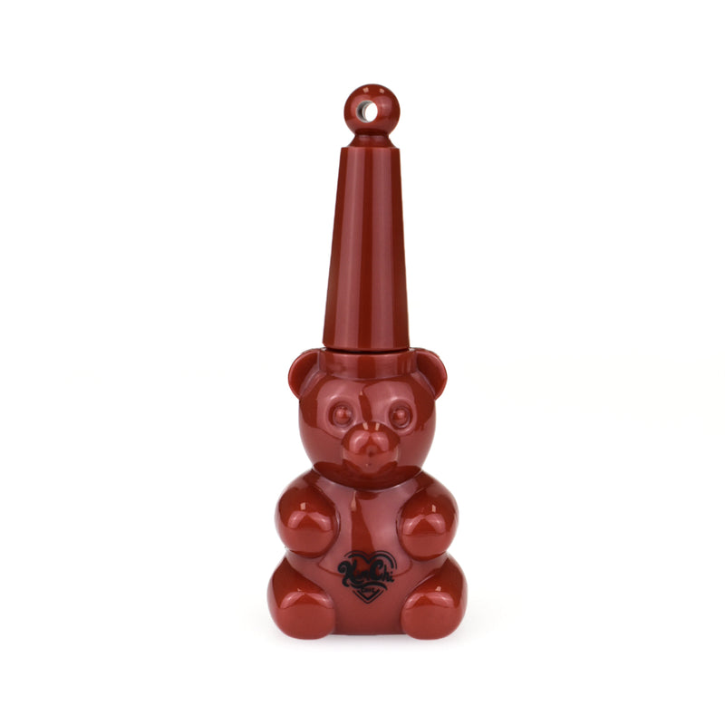 A red bear-shaped bottle with a tall, pointed cap and black design on the front.