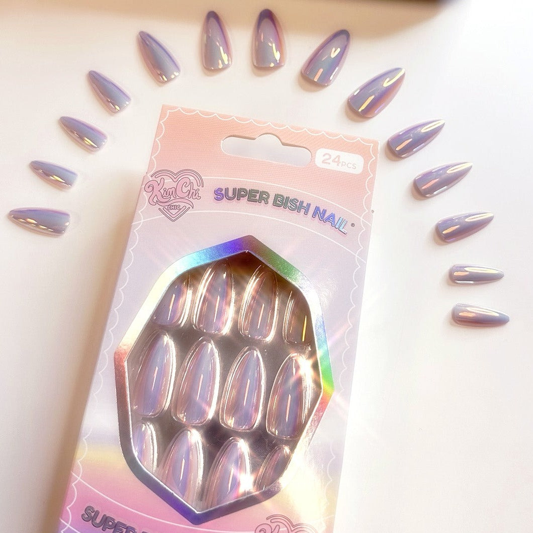 Set of iridescent press-on nails arranged around packaging.