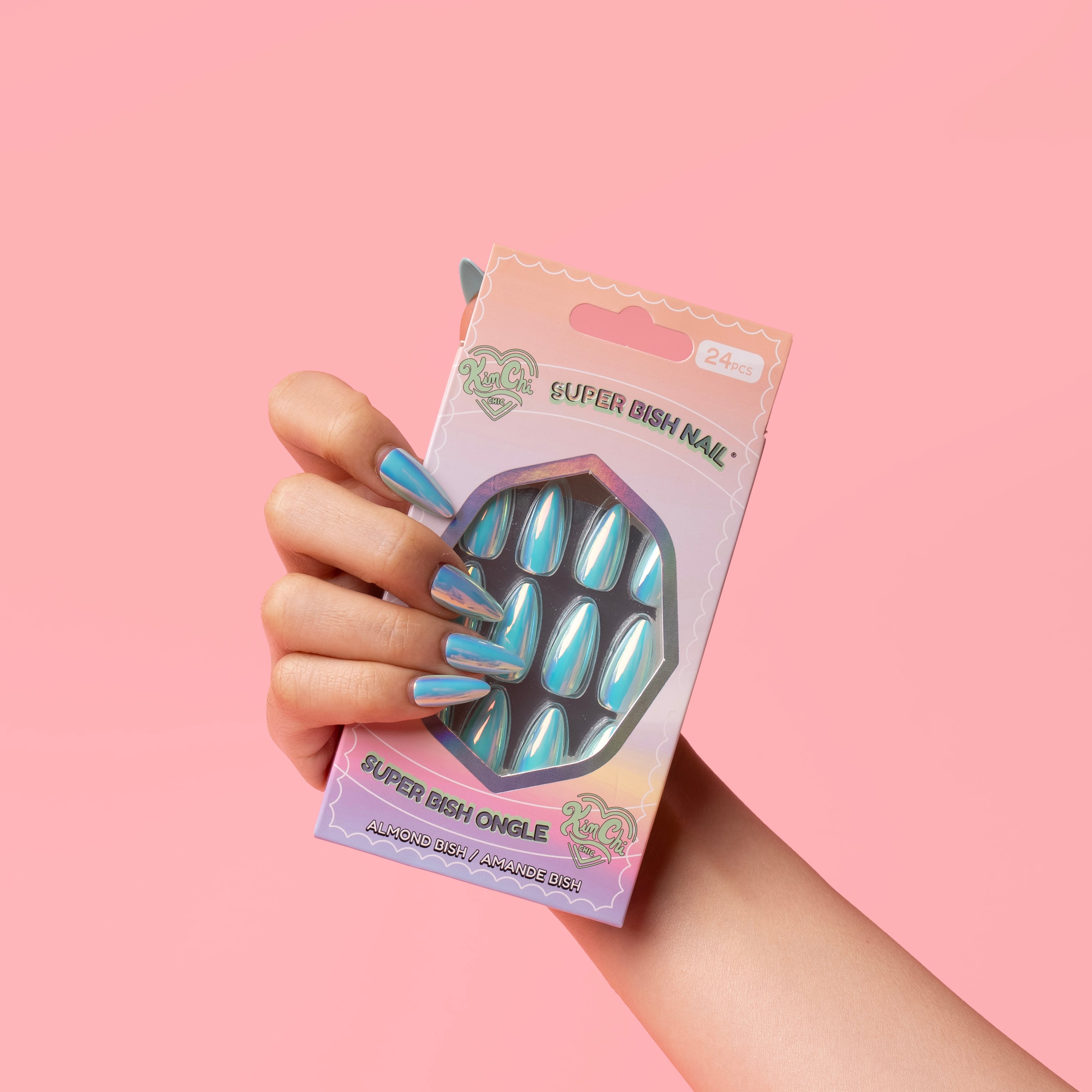 Hand holding a package of blue metallic fake nails against a pink background.