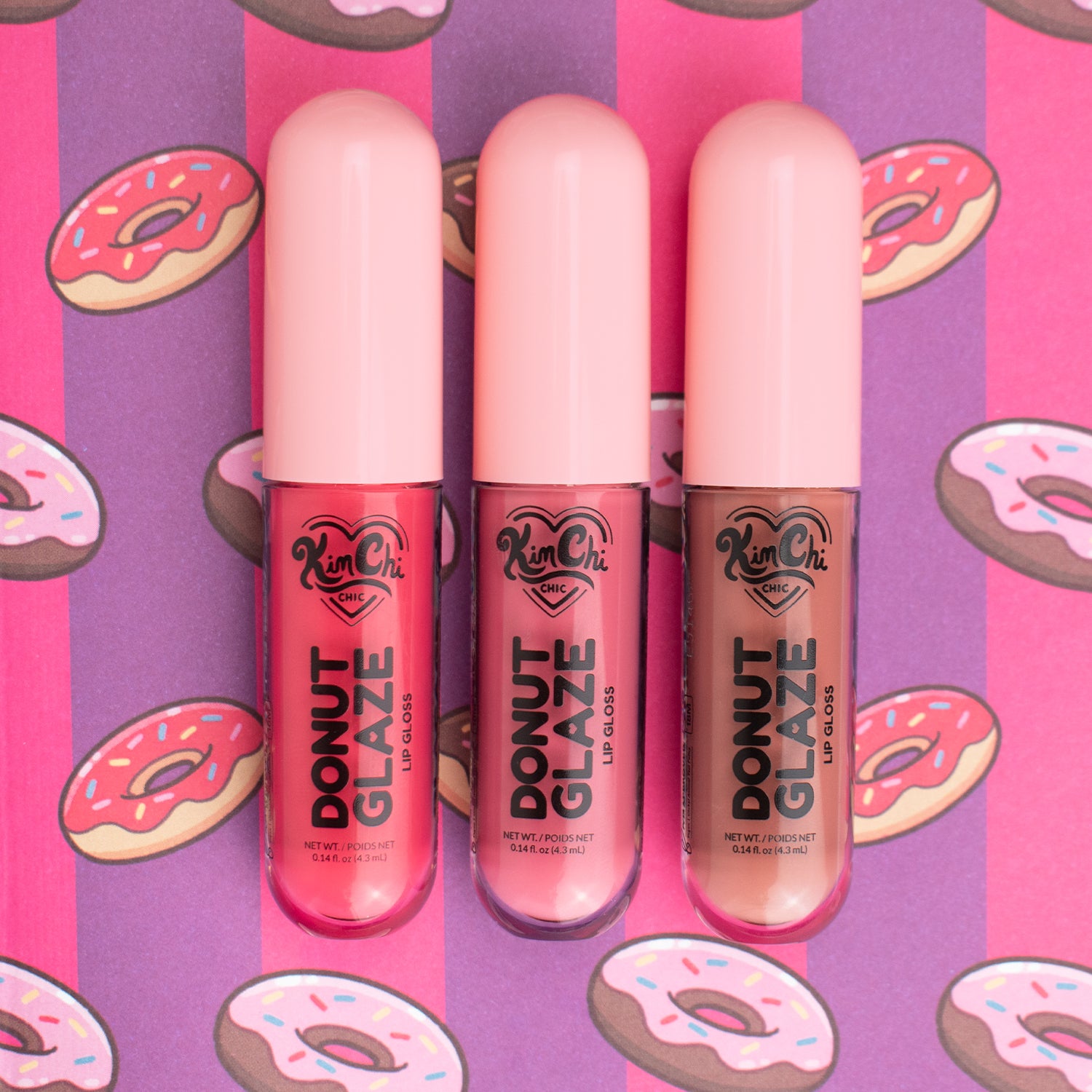Three lip glosses labeled 'Donut Glaze' on a colorful donut-patterned background.