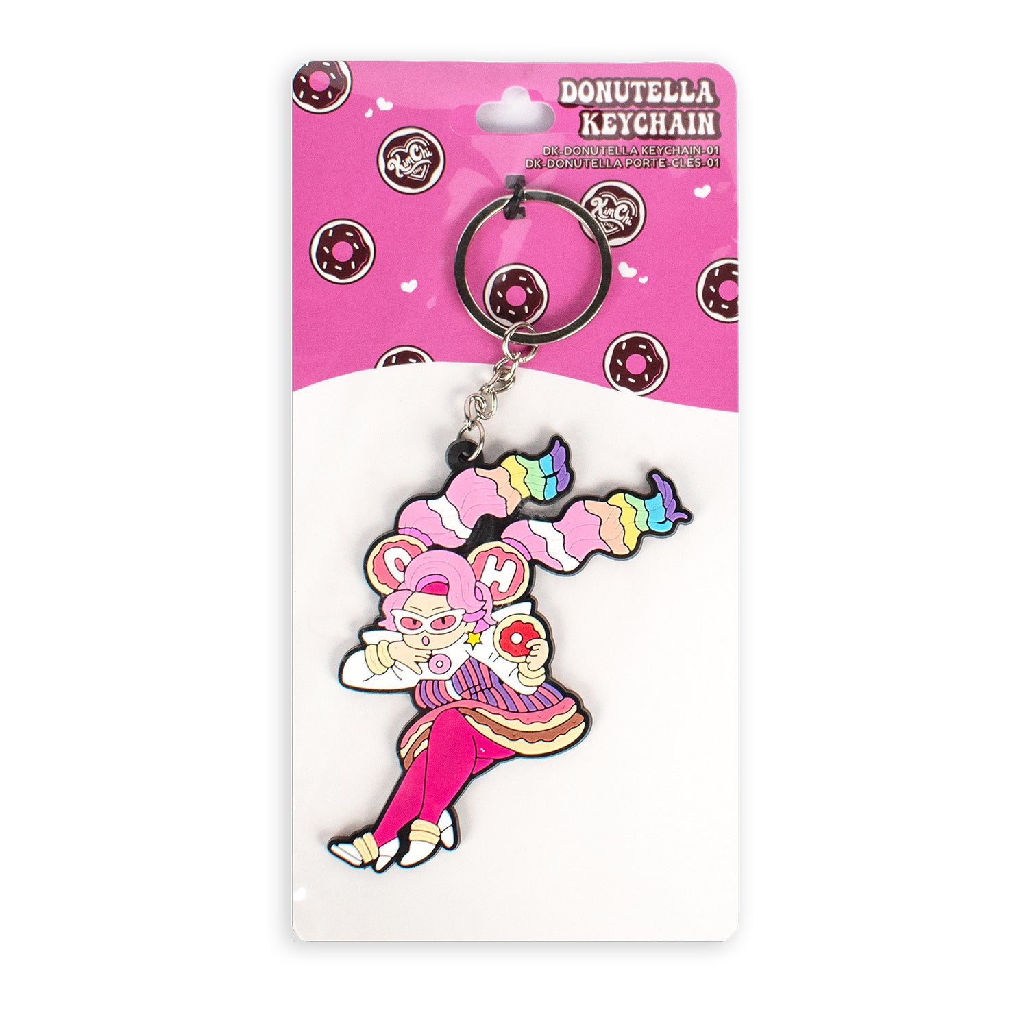 Colorful keychain featuring a character with pastel hair and a playful pose, packaged on a pink background with donut motifs.