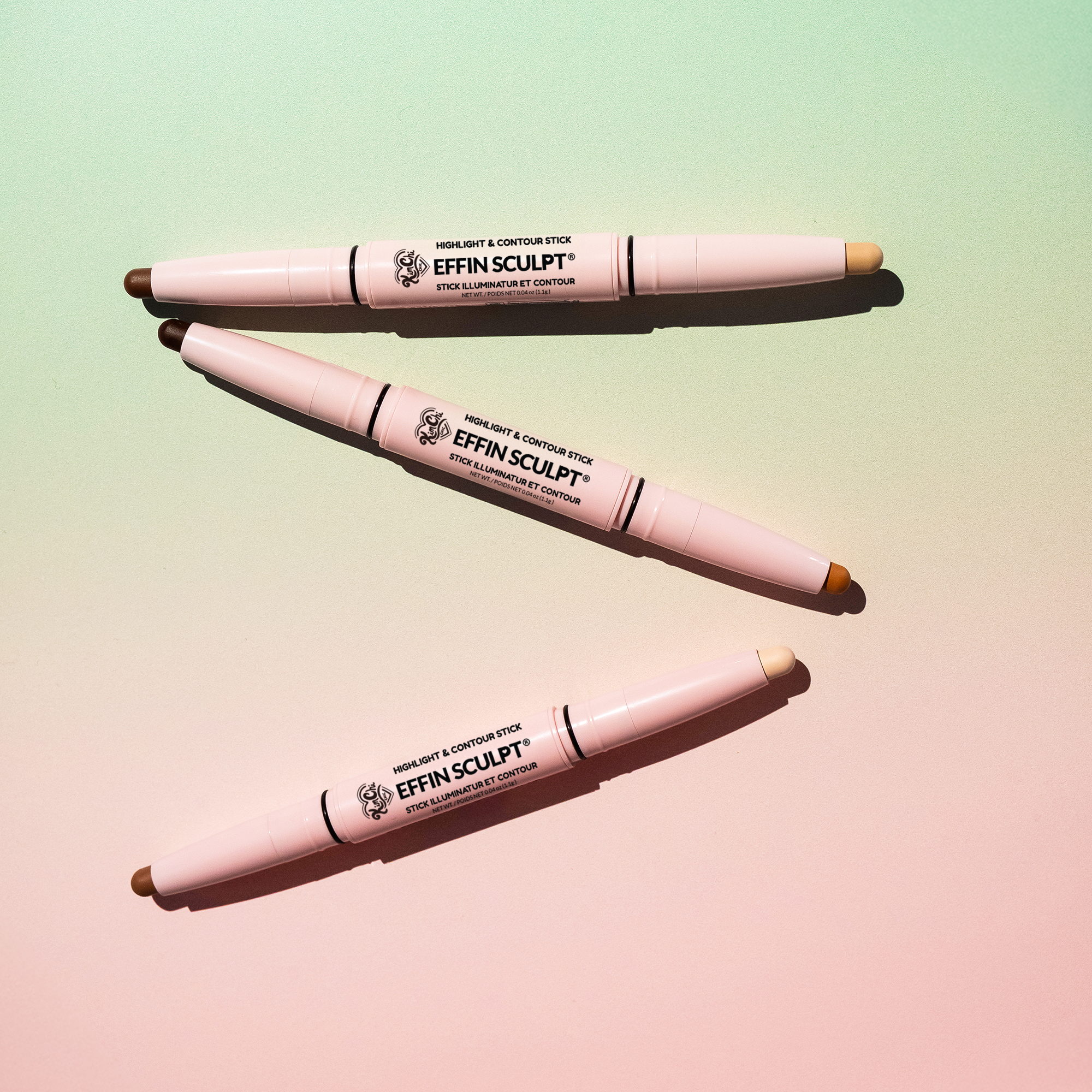 Three dual-ended makeup contouring sticks on a gradient background.