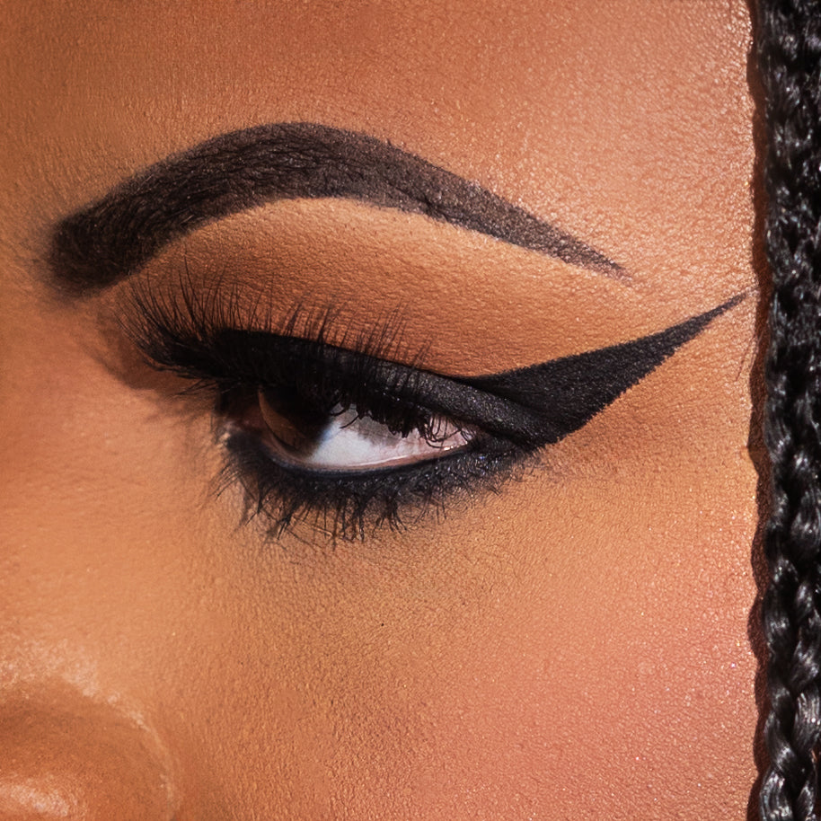 Close-up of an eye with dramatic winged eyeliner and long lashes