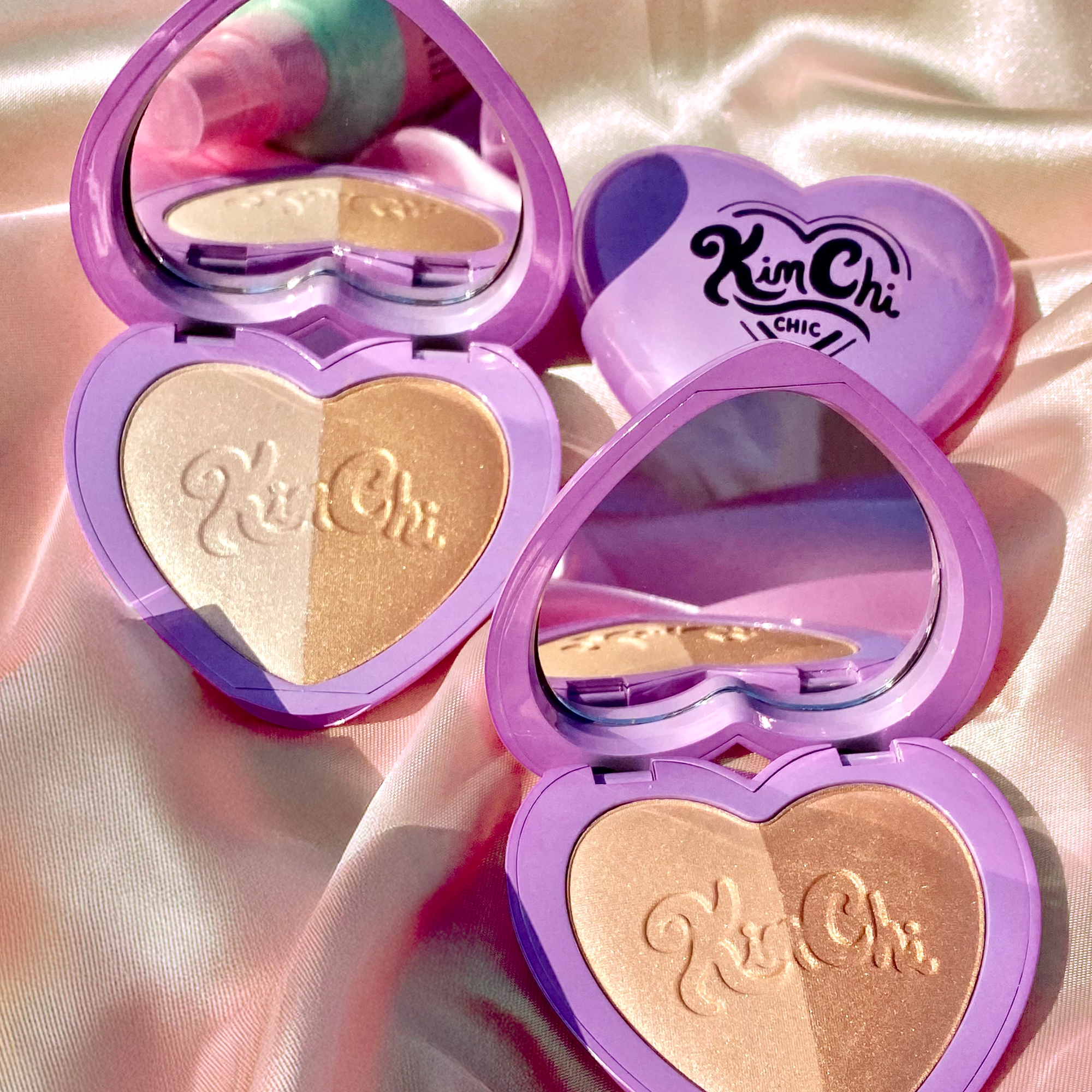 KimChi Chic heart-shaped highlighter duo in lavender packaging with shimmering gold and pearl shades.