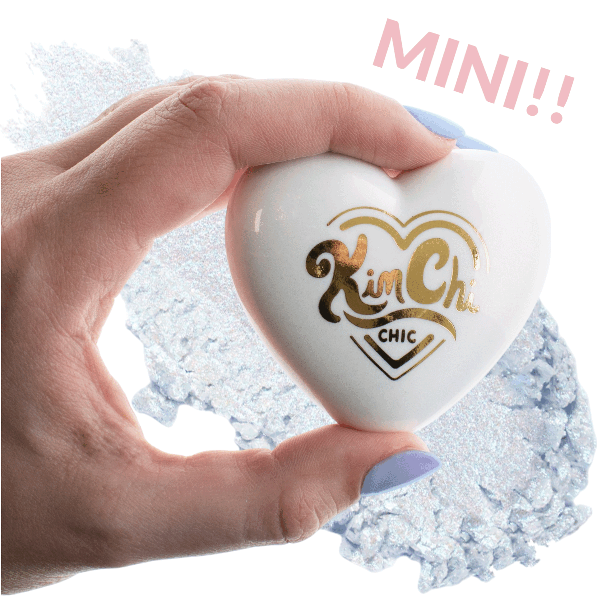 A hand holding a mini heart-shaped beauty product with a stylish design.