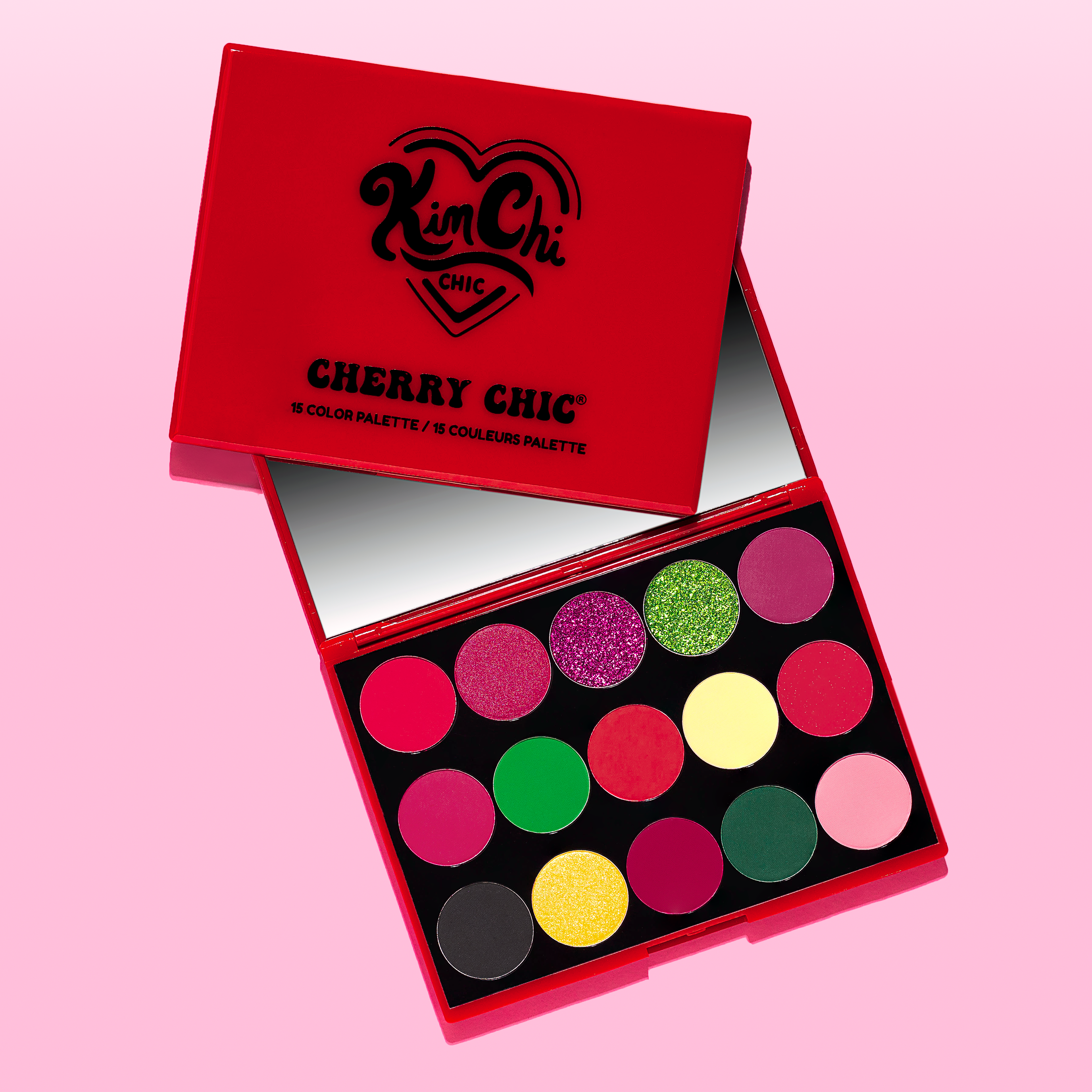 Colorful eyeshadow palette with multiple shades on a pink background.