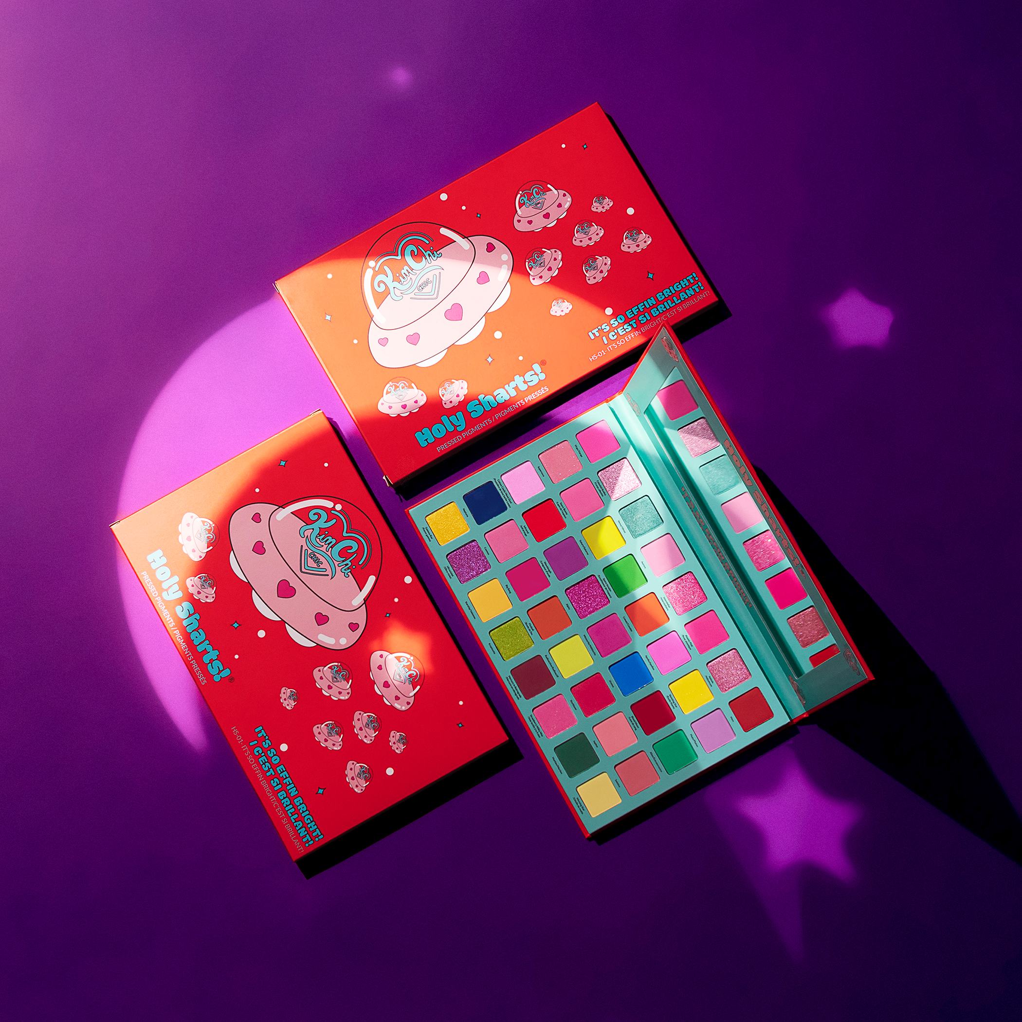 Colorful eyeshadow palette with cartoon UFO design on a purple background.