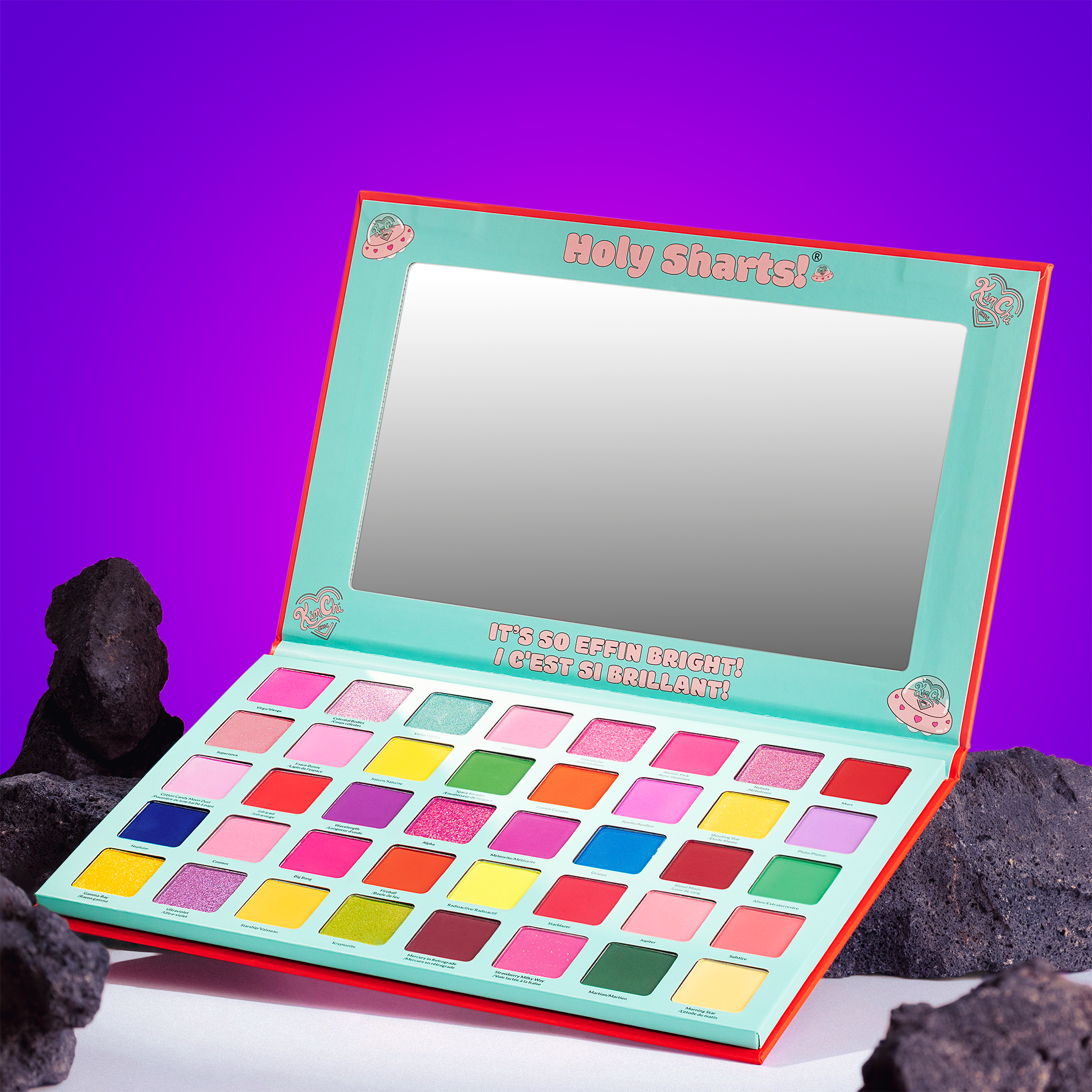 Colorful eyeshadow palette with mirror against a purple background