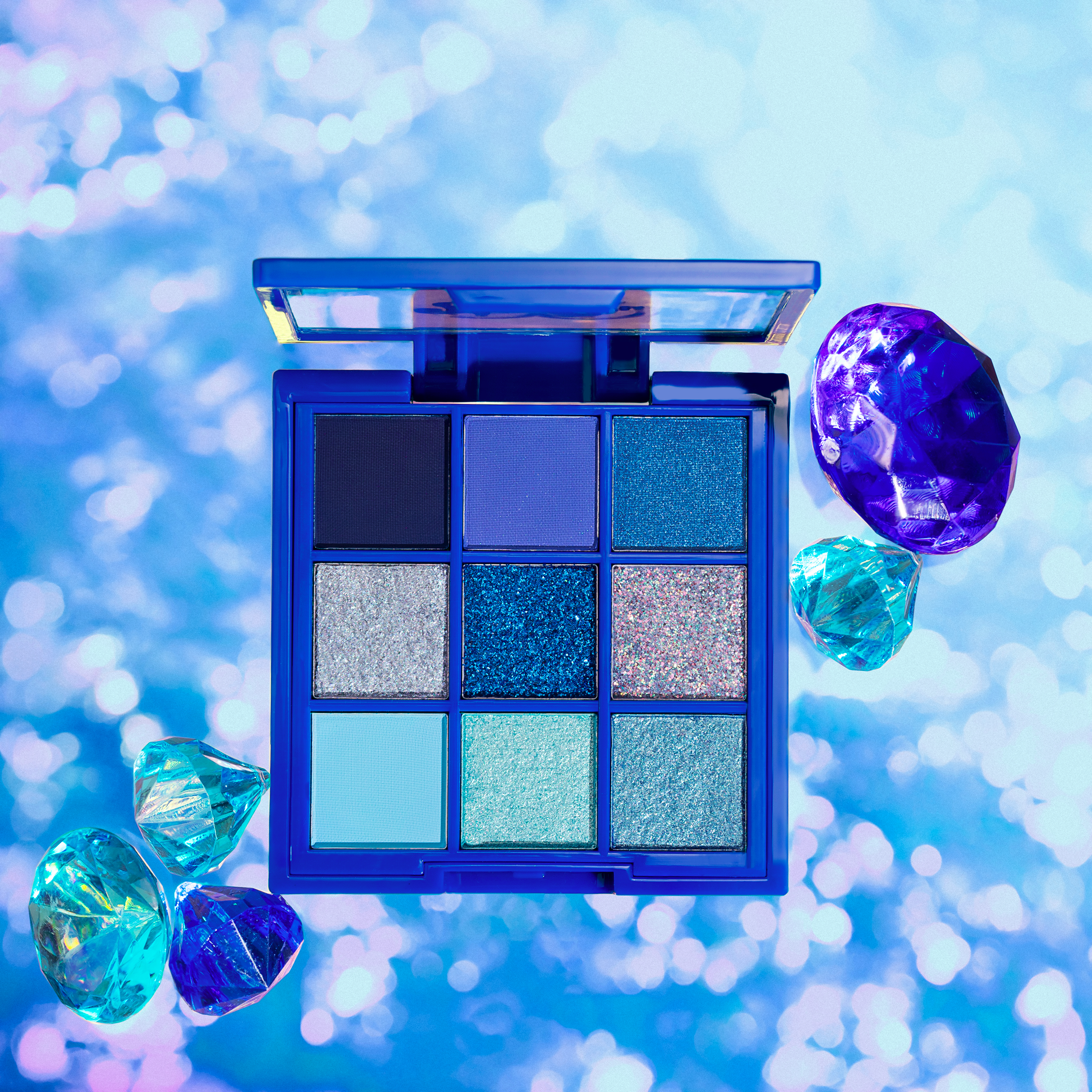 Blue-themed eyeshadow palette with sparkling gems