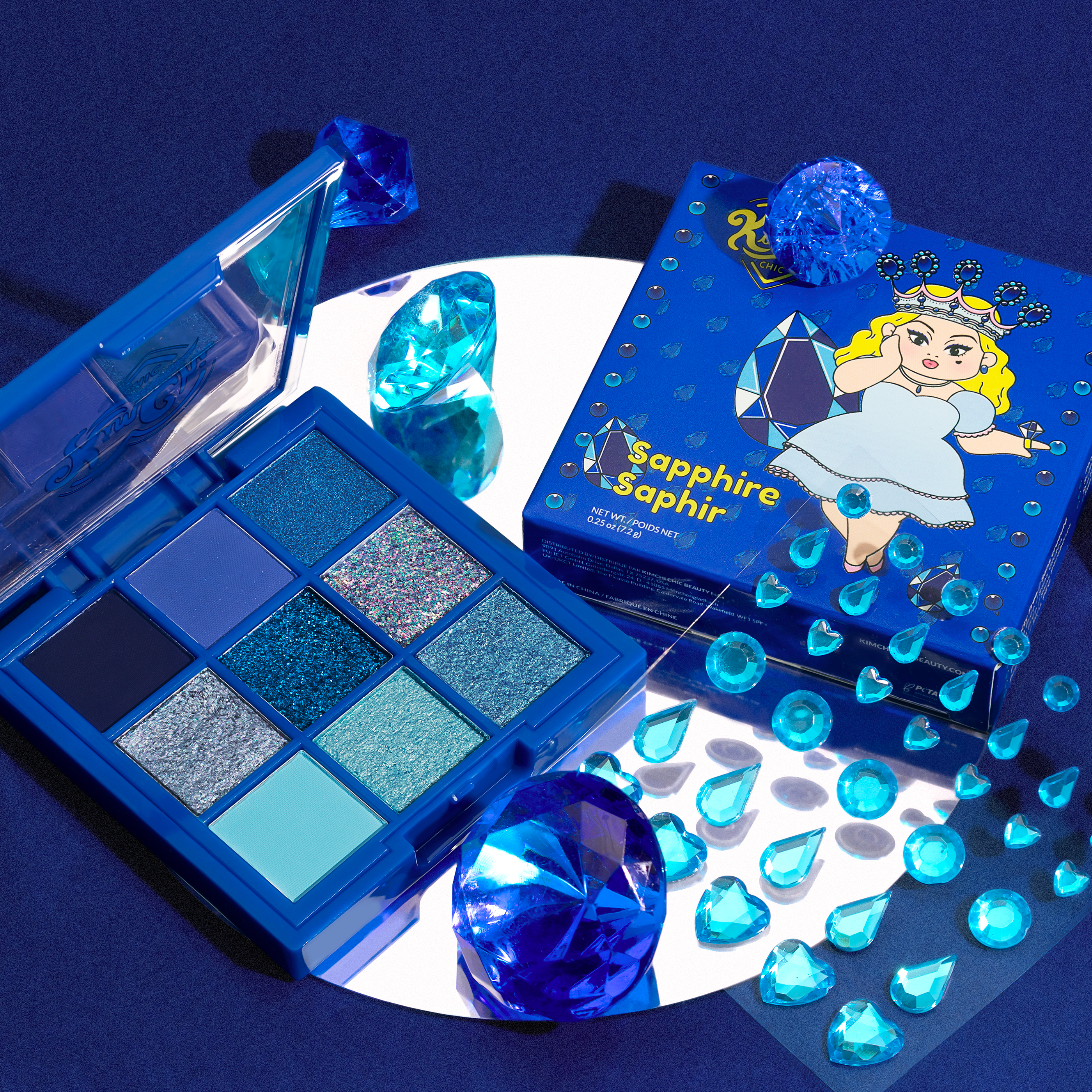 Blue-themed eyeshadow palette with sapphire decorations and packaging featuring a cartoon character.