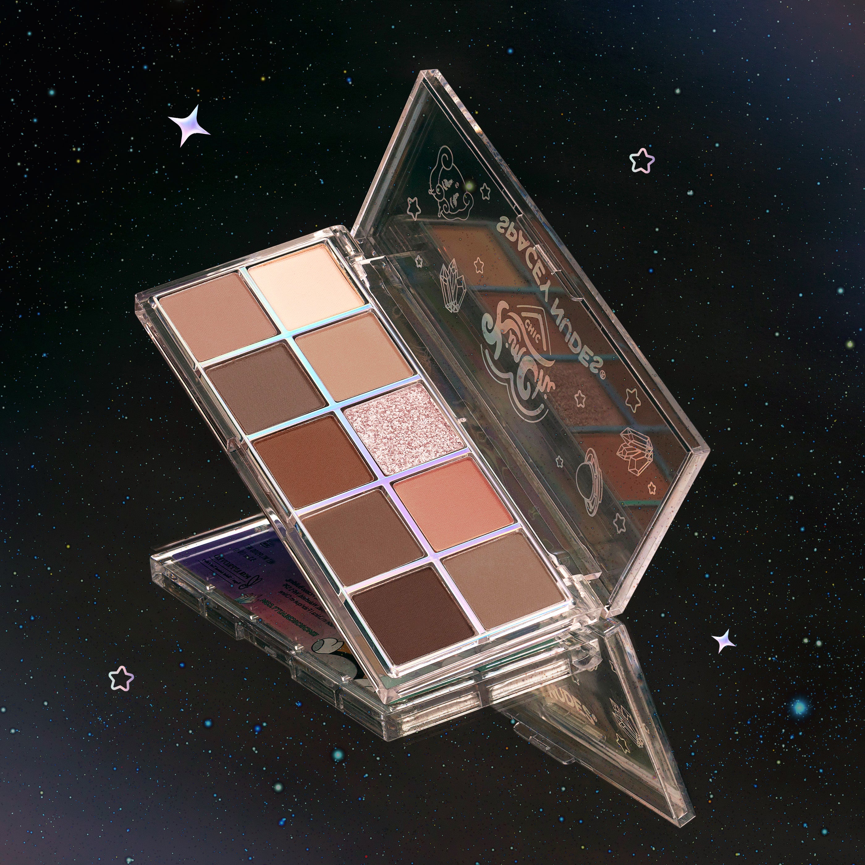 Open eyeshadow palette with neutral and shimmery shades against a starry background.