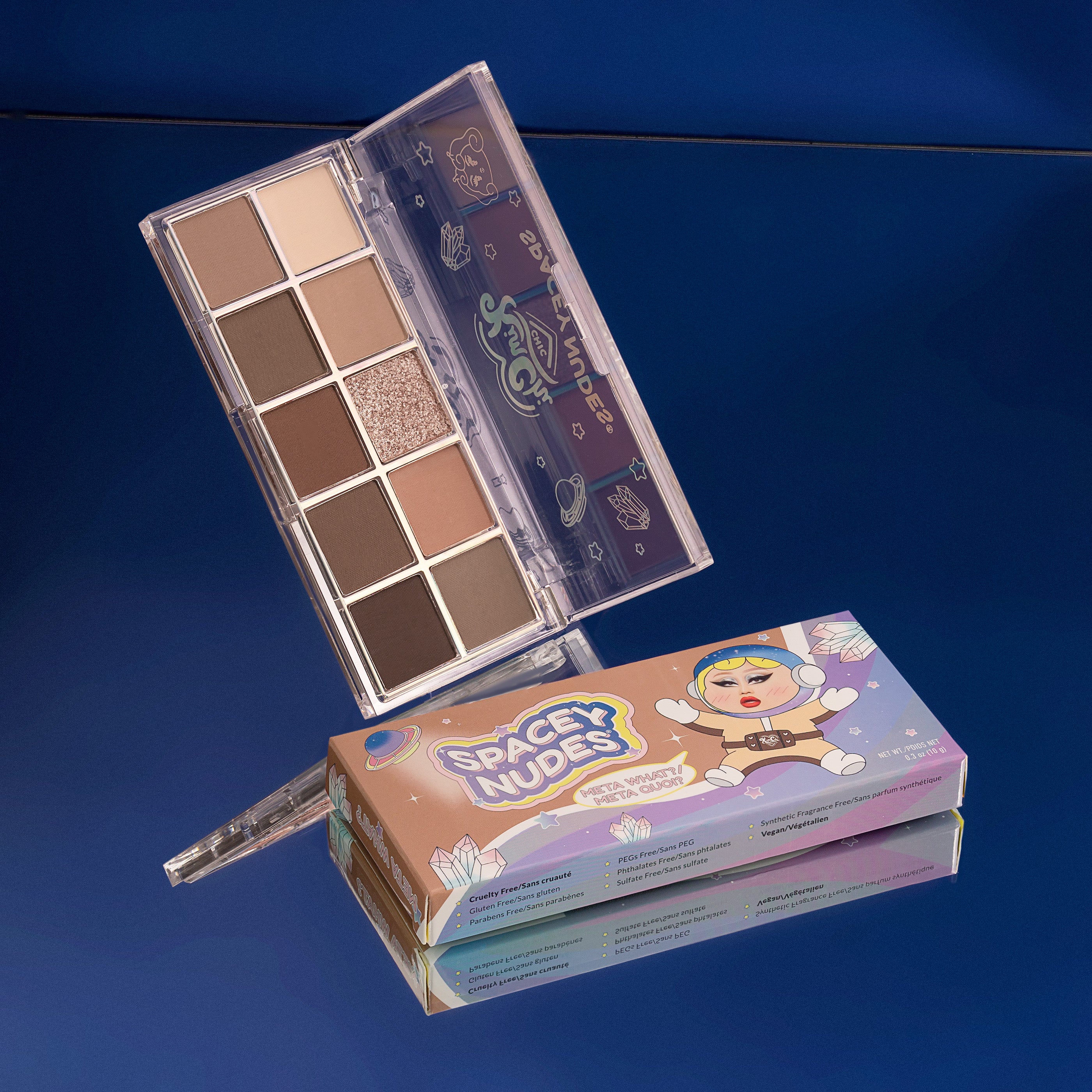 Makeup palette with box on a reflective surface against a blue background.