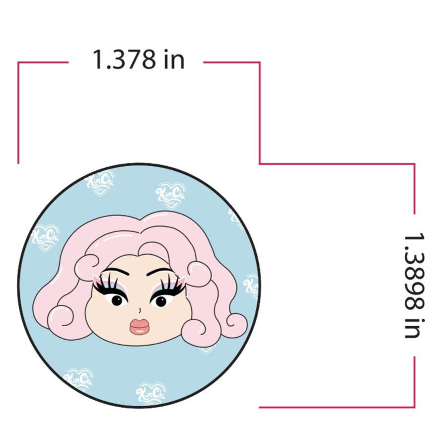 Illustration of a doll-like face with pink hair in a circular frame, dimensions 1.378 inches by 1.3898 inches.