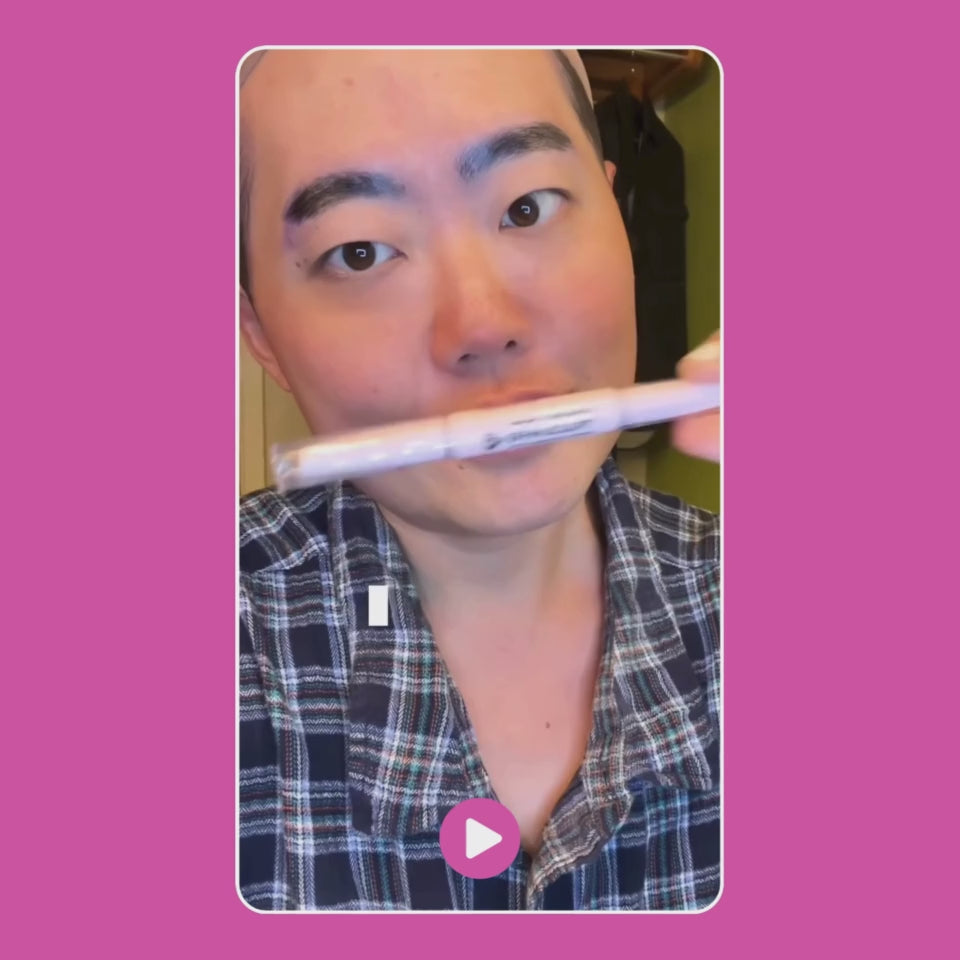 Person holding a pen while posing for the camera