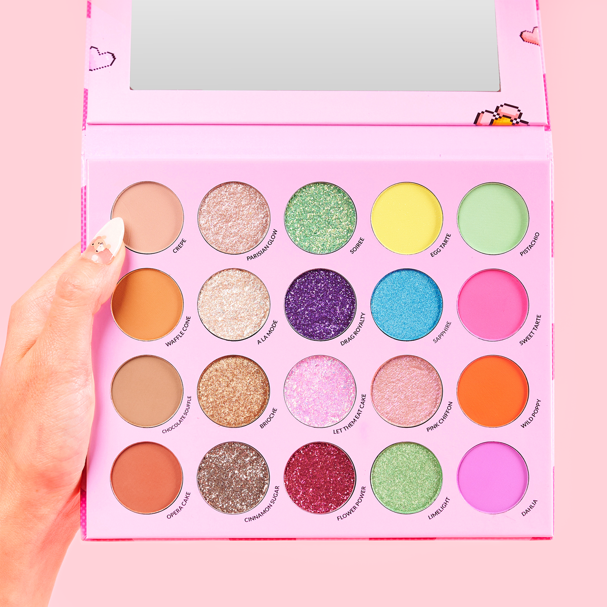 Hand holding a colorful eyeshadow palette with 18 shades.