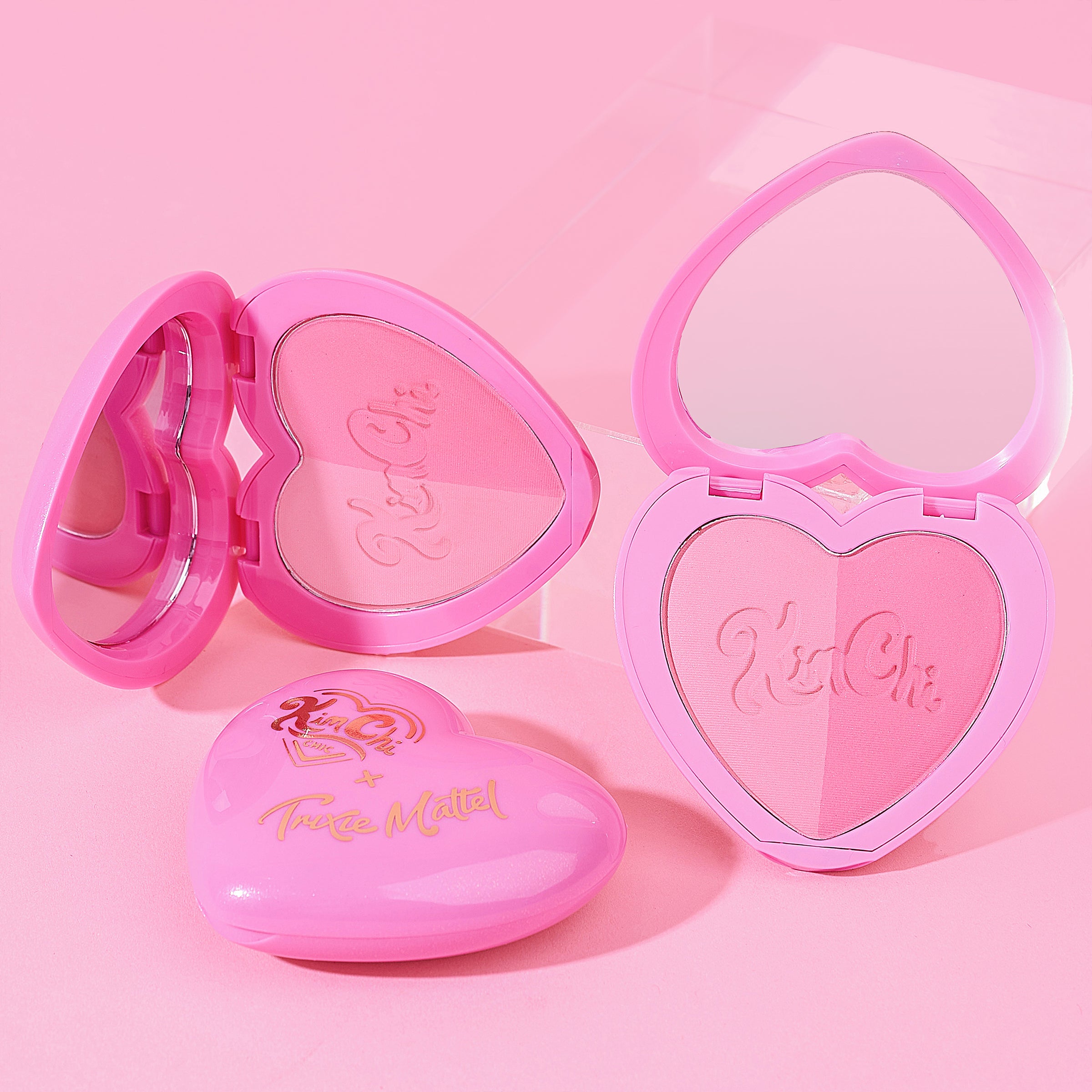 Heart-shaped pink makeup compacts with mirrors.