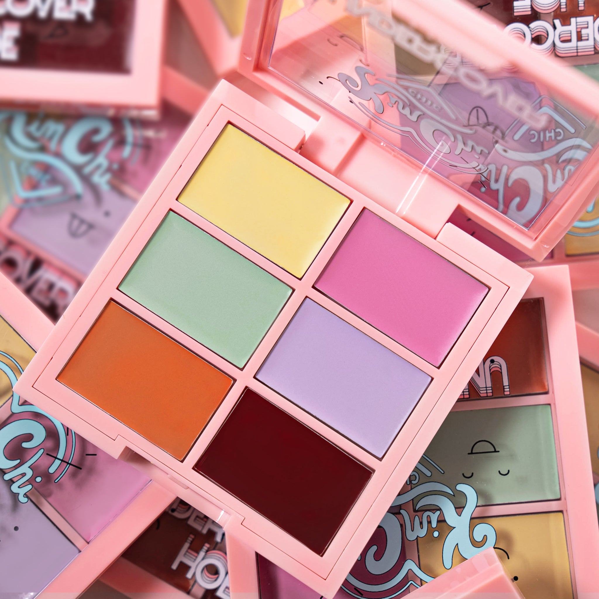 Colorful makeup palette with six shades in a pink case.