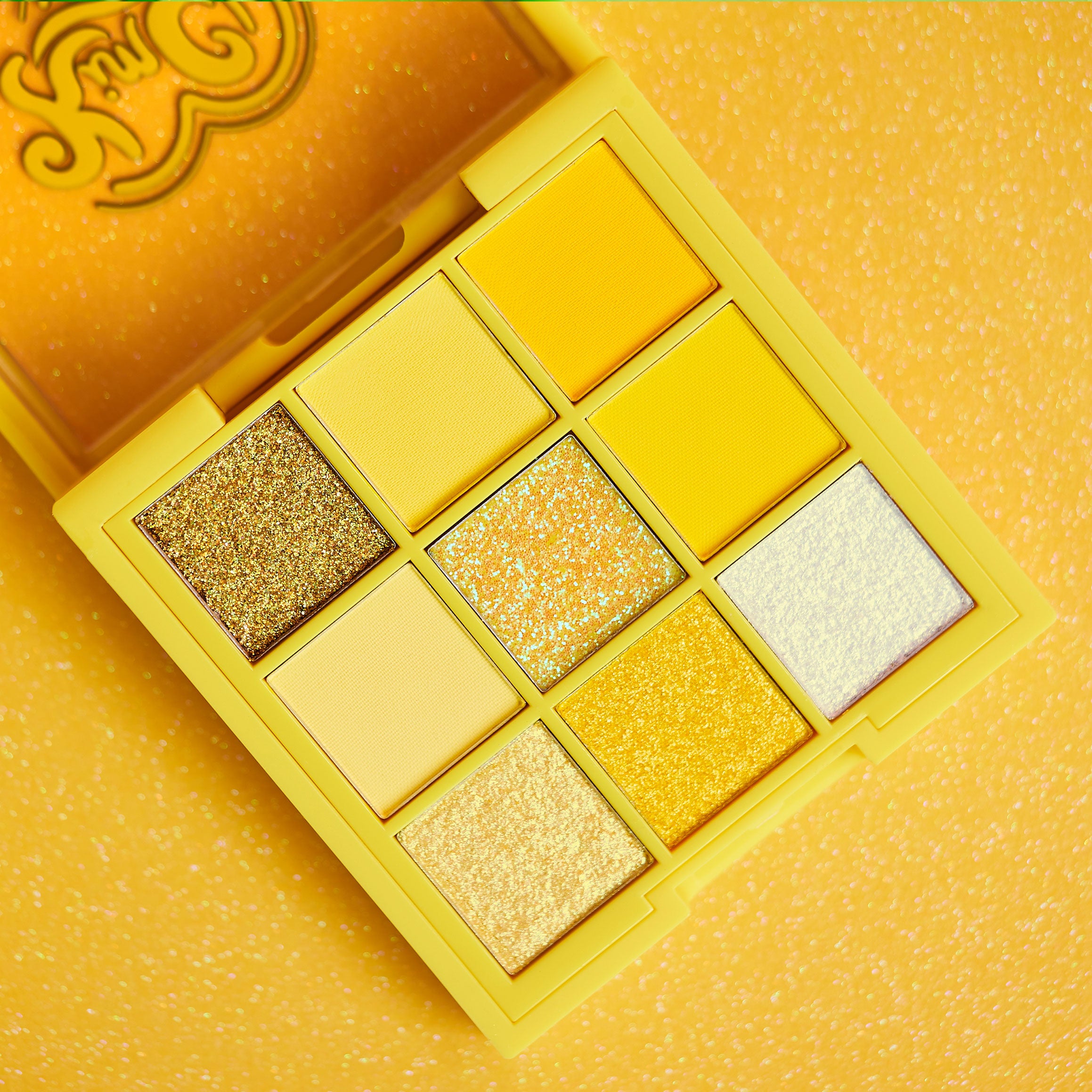 Yellow and gold eyeshadow palette with glitter shades