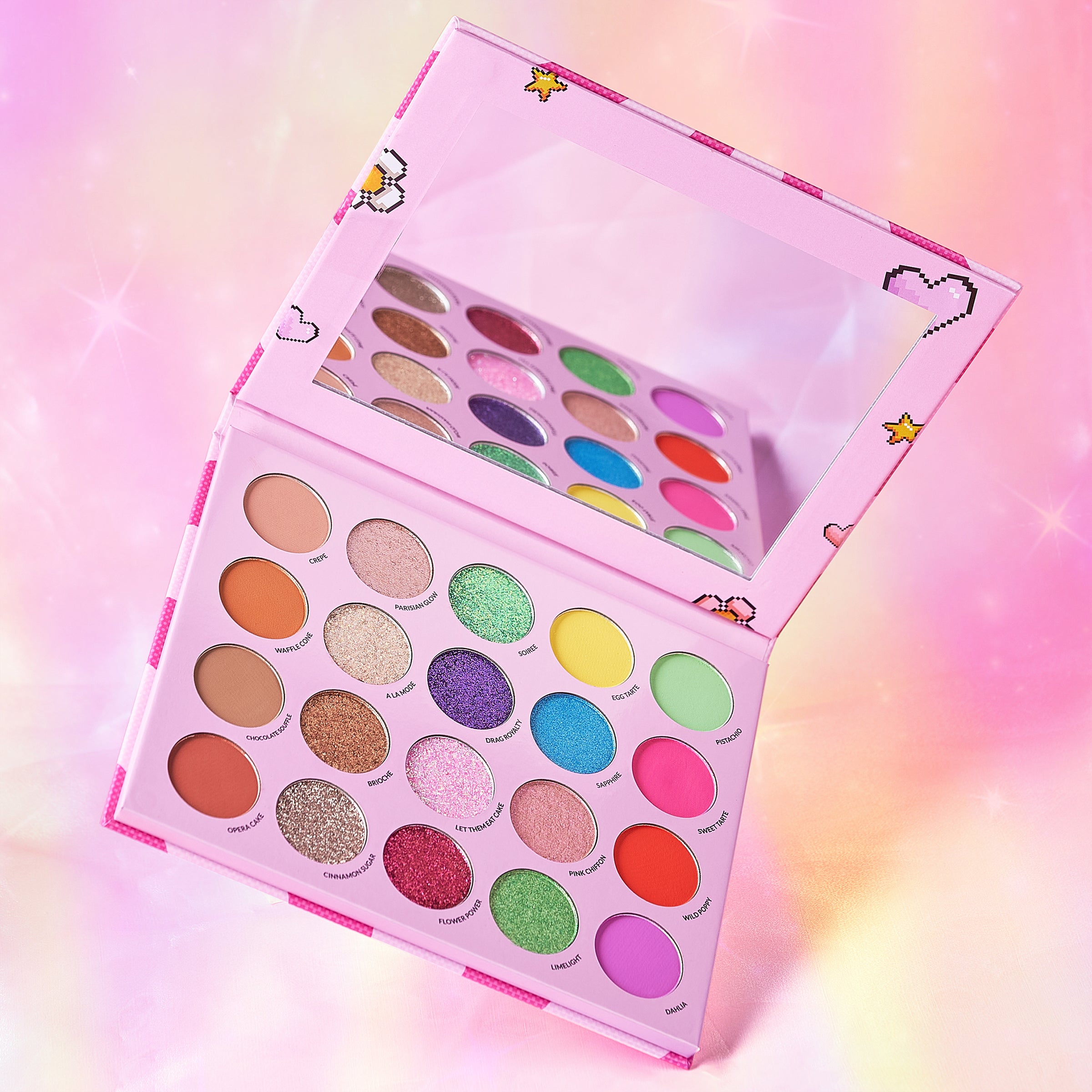 Colorful eyeshadow palette with multiple shades on a pink background.