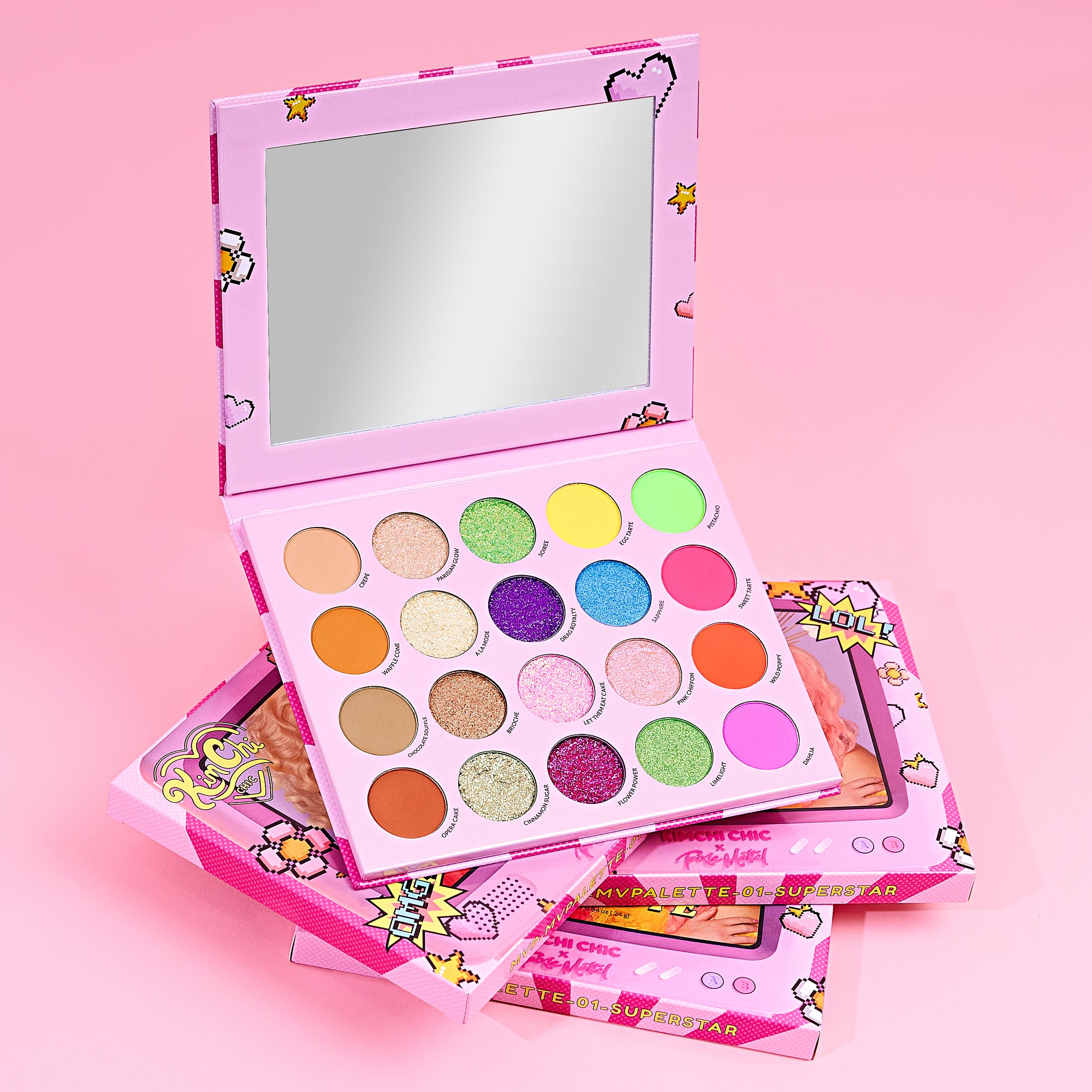 Colorful eyeshadow palette with mirror on a pink background