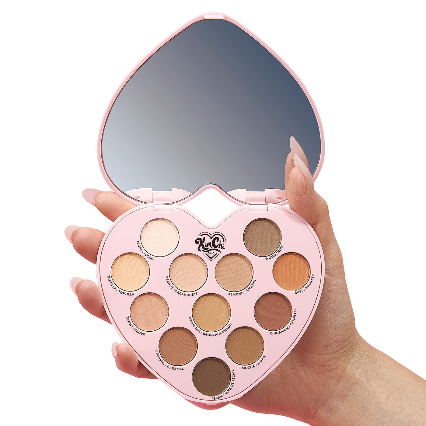 Hand holding a heart-shaped eyeshadow palette with a mirror.