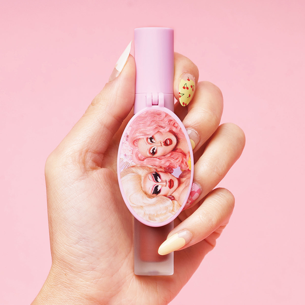 Person holding pink makeup item with illustrations of two characters