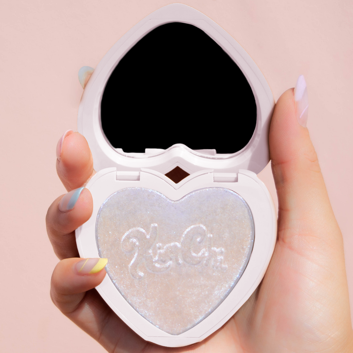 grouped KimChi-Chic-Beauty-Thailor-Collection-Pearl-Gone-Wild-Pressed-Shimmer-Highlighter-01-Hope heart shaped compact with shimmery highlighter in hand